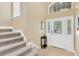 Inviting entryway with tile floors, staircase, and a decorative glass front door at 886 Suffolk Pl, Davenport, FL 33896
