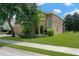 Attractive home featuring lush landscaping, a two-car garage, and a screened-in porch at 886 Suffolk Pl, Davenport, FL 33896