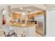 Well-equipped kitchen with stainless steel appliances, granite countertops, and breakfast bar seating, offering a casual dining space at 886 Suffolk Pl, Davenport, FL 33896