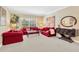 Comfortable living room featuring plush sofas, a coffee table, and an elegant console table with a mirror at 886 Suffolk Pl, Davenport, FL 33896