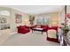 Cozy living room with plush red sofas, a coffee table, and a large window for natural light at 886 Suffolk Pl, Davenport, FL 33896