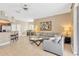 Open living room with tile flooring, modern furniture, and a breakfast bar connecting to the adjacent kitchen at 886 Suffolk Pl, Davenport, FL 33896