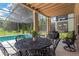 The outdoor patio offers plenty of space for seating, dining, and entertaining by the screened-in pool at 886 Suffolk Pl, Davenport, FL 33896