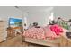Bedroom with a bed, a tv on the dresser and an open doorway at 890 Marisa Ln, Kissimmee, FL 34744