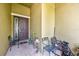 Covered front porch with seating, plants and view of front door at 890 Marisa Ln, Kissimmee, FL 34744