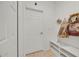 Small hallway with a white door and shelving with home decor at 890 Marisa Ln, Kissimmee, FL 34744