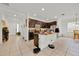 Open kitchen with an island, dark cabinets, tile floors and stainless steel appliances at 890 Marisa Ln, Kissimmee, FL 34744