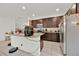 Open kitchen with a breakfast bar, stainless steel appliances and dark wood cabinets at 890 Marisa Ln, Kissimmee, FL 34744