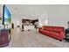 Open living room with tiled flooring, a sofa, TV and open kitchen at 890 Marisa Ln, Kissimmee, FL 34744