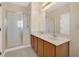 Bright bathroom featuring double sinks and a glass enclosed shower at 12975 Calderdale Ave, Windermere, FL 34786