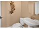 Powder room with decorative butterflies and a pedestal sink at 12975 Calderdale Ave, Windermere, FL 34786