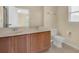 Bright bathroom featuring a double sink vanity and a toilet at 12975 Calderdale Ave, Windermere, FL 34786