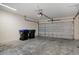 Spacious garage with gray concrete floors, garage door, and overhead lighting at 12975 Calderdale Ave, Windermere, FL 34786