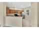 Functional kitchen featuring wood cabinetry, stainless steel appliances, and a cozy dining nook at 12975 Calderdale Ave, Windermere, FL 34786