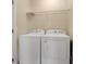 Neat laundry room featuring a washer and dryer, as well as a shelf for storage at 12975 Calderdale Ave, Windermere, FL 34786