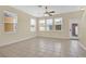 Bright living space with tile floors, ceiling fan, and multiple windows, perfect for entertaining at 12975 Calderdale Ave, Windermere, FL 34786