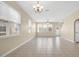Expansive living room with tile flooring, chandelier, and plenty of windows for sunlight at 12975 Calderdale Ave, Windermere, FL 34786