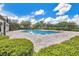 Community pool surrounded by lush landscaping and trees, perfect for relaxing at 12975 Calderdale Ave, Windermere, FL 34786