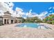 Community pool and clubhouse surrounded by lush landscaping and trees, perfect for relaxing at 12975 Calderdale Ave, Windermere, FL 34786