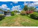 A spacious backyard that features a well-maintained lawn and lush landscaping at 1327 Glenview Ln, Lakeland, FL 33813