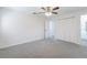 Spacious bedroom with neutral walls, plush carpeting, and double door closet for ample storage at 1327 Glenview Ln, Lakeland, FL 33813