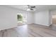 Bright bedroom featuring modern flooring, neutral walls, and access to a screened in patio at 1327 Glenview Ln, Lakeland, FL 33813