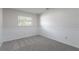 Bedroom with carpet, base molding, a window that provides natural light, and neutral paint at 1327 Glenview Ln, Lakeland, FL 33813