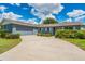 Charming single-story home featuring a gray brick exterior, attached garage, and well-maintained landscaping at 1327 Glenview Ln, Lakeland, FL 33813