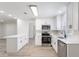 Updated kitchen featuring stainless steel appliances, white cabinets and countertops, with bright lighting at 1327 Glenview Ln, Lakeland, FL 33813