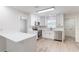 Modern kitchen featuring stainless steel appliances, white cabinets, and updated flooring with bar style countertop at 1327 Glenview Ln, Lakeland, FL 33813