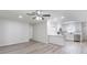 Open-concept living space that shows kitchen with bar style countertops, modern flooring and updated lighting at 1327 Glenview Ln, Lakeland, FL 33813