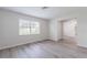 Bright living room with neutral walls, modern flooring, and a large window for ample natural light at 1327 Glenview Ln, Lakeland, FL 33813