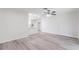 Open living space with modern flooring and bright lighting, seamlessly connects to the adjacent kitchen at 1327 Glenview Ln, Lakeland, FL 33813