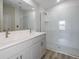 Modern bathroom featuring double sinks, sleek fixtures, and a glass-enclosed shower at 9619 Sw 62Nd Ct, Ocala, FL 34476