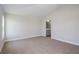 Well-lit bedroom boasts neutral carpeting and paint, with a bathroom view at 9619 Sw 62Nd Ct, Ocala, FL 34476