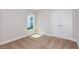 Bright bedroom featuring double closet, neutral carpet, and a sunlit window at 9619 Sw 62Nd Ct, Ocala, FL 34476