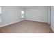 Spacious bedroom with neutral carpet and trim, featuring large windows at 9619 Sw 62Nd Ct, Ocala, FL 34476
