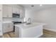 Bright kitchen featuring gray cabinets, stainless steel appliances, a kitchen island, and white countertops at 9619 Sw 62Nd Ct, Ocala, FL 34476