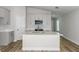 Modern kitchen features white cabinets, stainless steel appliances, gray countertops and an island with a sink at 9619 Sw 62Nd Ct, Ocala, FL 34476