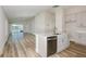 Modern kitchen featuring stainless appliances, white cabinets, gray countertops and an open concept view of living area at 9619 Sw 62Nd Ct, Ocala, FL 34476