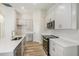 Bright kitchen with gray cabinets, stainless steel appliances and white countertops at 9619 Sw 62Nd Ct, Ocala, FL 34476