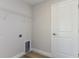 Functional laundry room features hookups and overhead shelving for storage and convenience at 9619 Sw 62Nd Ct, Ocala, FL 34476