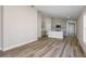 Open-concept living area featuring wood-look floors and a modern kitchen in the background at 9619 Sw 62Nd Ct, Ocala, FL 34476