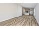 Spacious open-concept living area featuring wood-look floors and a modern kitchen in the background at 9619 Sw 62Nd Ct, Ocala, FL 34476