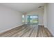 Bright living room features wood-look floors and sliding glass doors leading to the screened in patio at 9619 Sw 62Nd Ct, Ocala, FL 34476