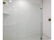 Detailed shot of a glass shower with textured white tile and a rainfall shower head at 9619 Sw 62Nd Ct, Ocala, FL 34476