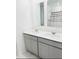 Bathroom featuring double sinks with gray cabinets, white countertops and a shower with curtain at 2847 Big Sur Rd, Davenport, FL 33837