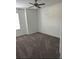 Cozy bedroom with plush carpet flooring, neutral walls, and a modern ceiling fan at 2847 Big Sur Rd, Davenport, FL 33837