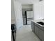 Kitchen showcasing gray cabinetry, stainless steel appliances, and sleek countertops at 2847 Big Sur Rd, Davenport, FL 33837