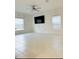 Bright living room with tile flooring, modern ceiling fan, and multiple windows for natural light at 2847 Big Sur Rd, Davenport, FL 33837